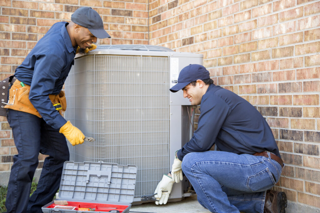 HVAC technicians installing AC
